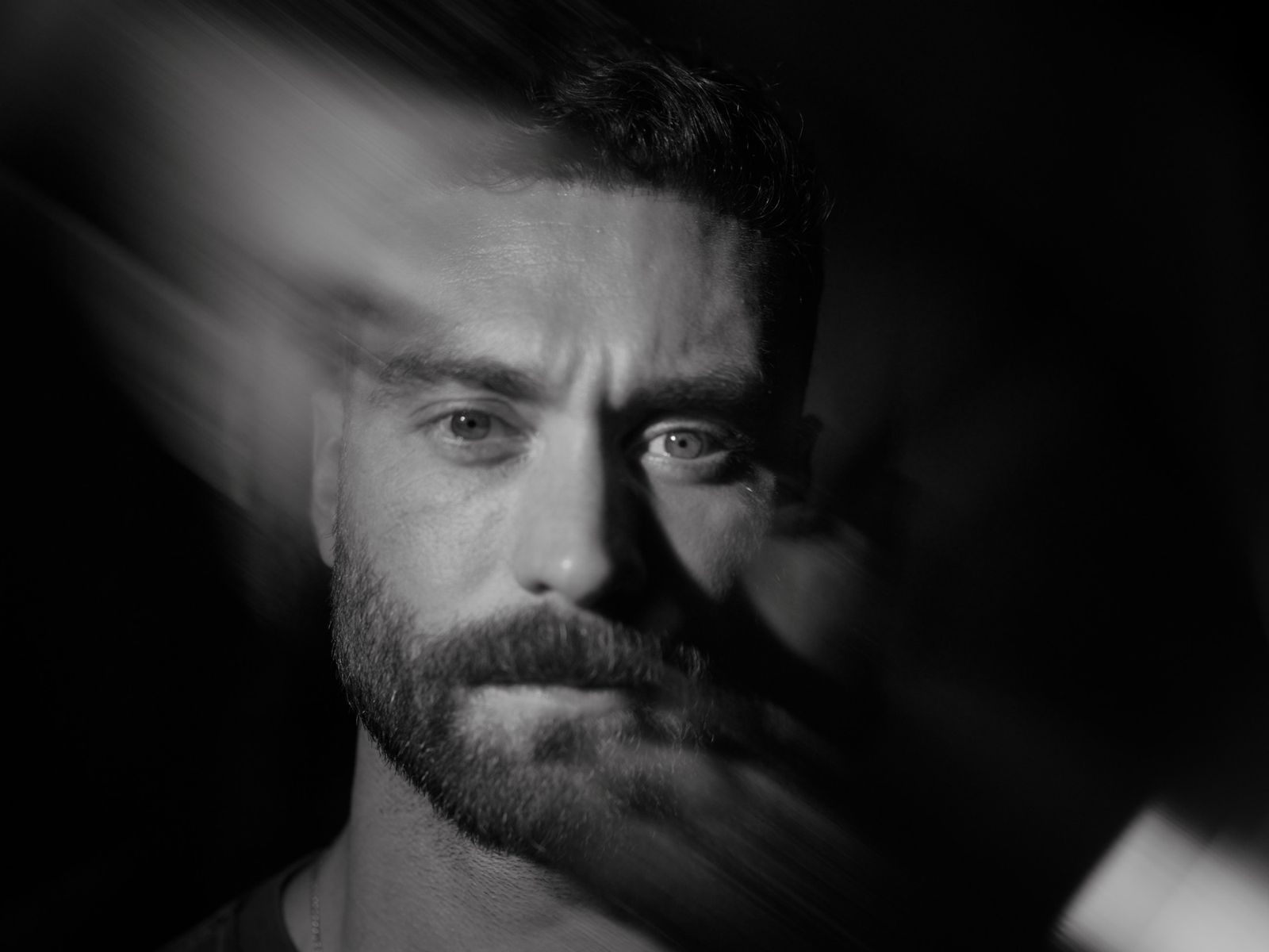 Black and white close-up of an athlete's face mid-motion