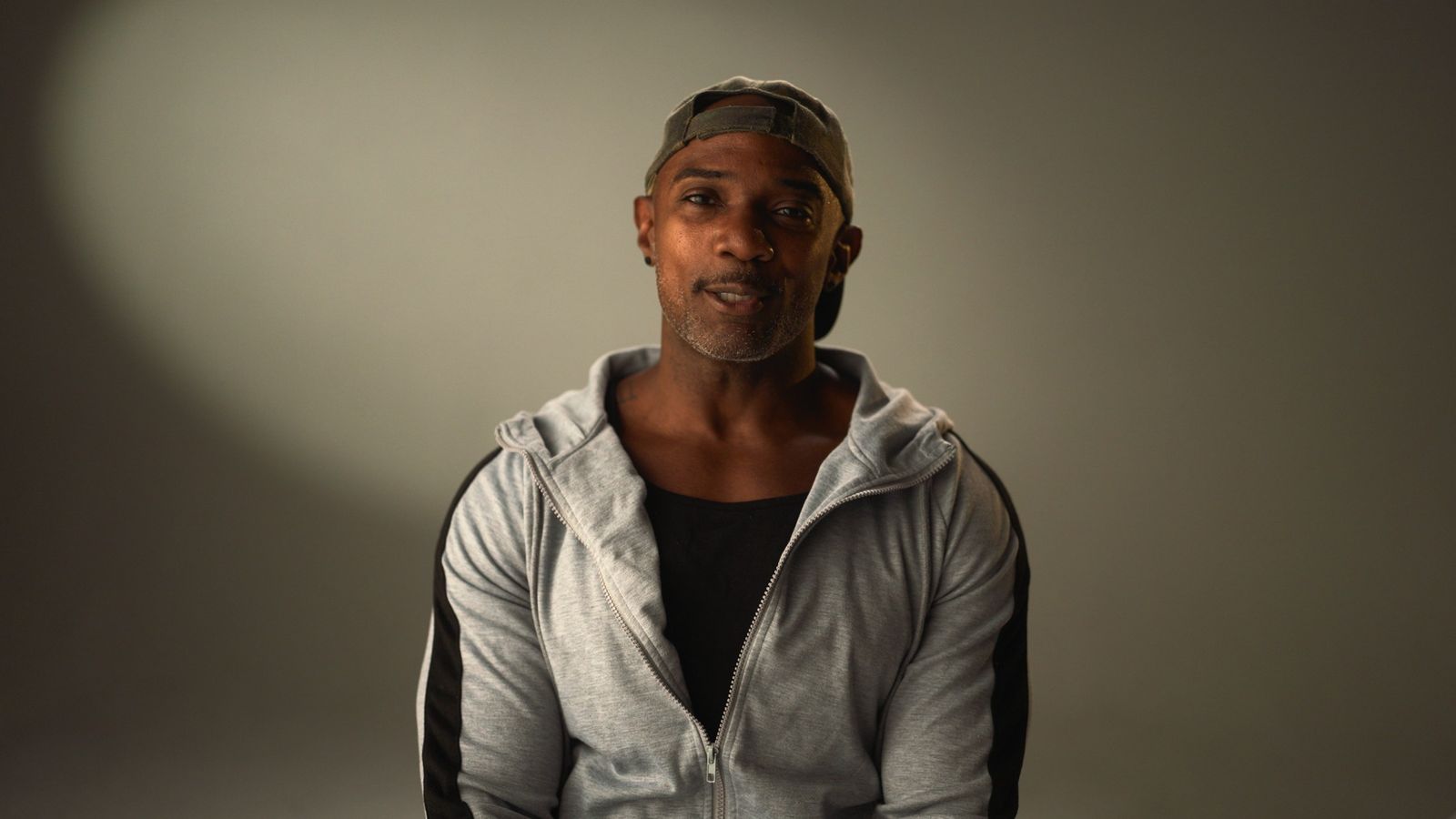 An athlete interviewed in a hooded jacket