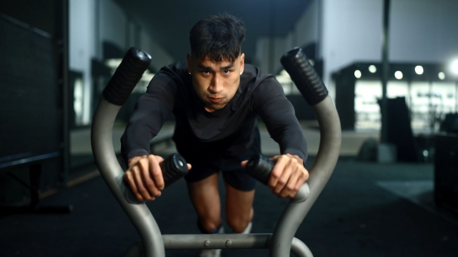 A young athlete on a bike in the gym