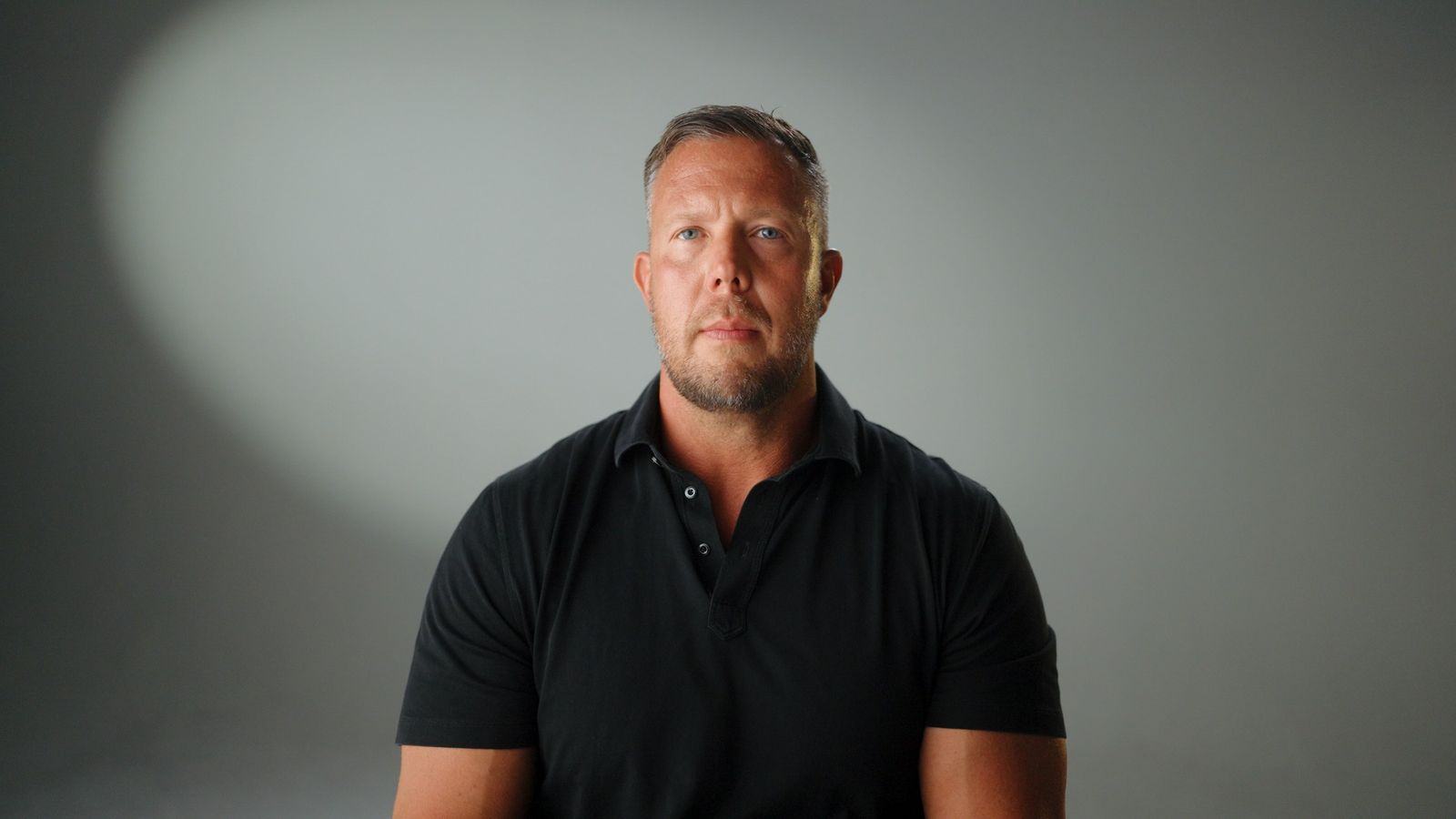 An interview subject against a gray backdrop