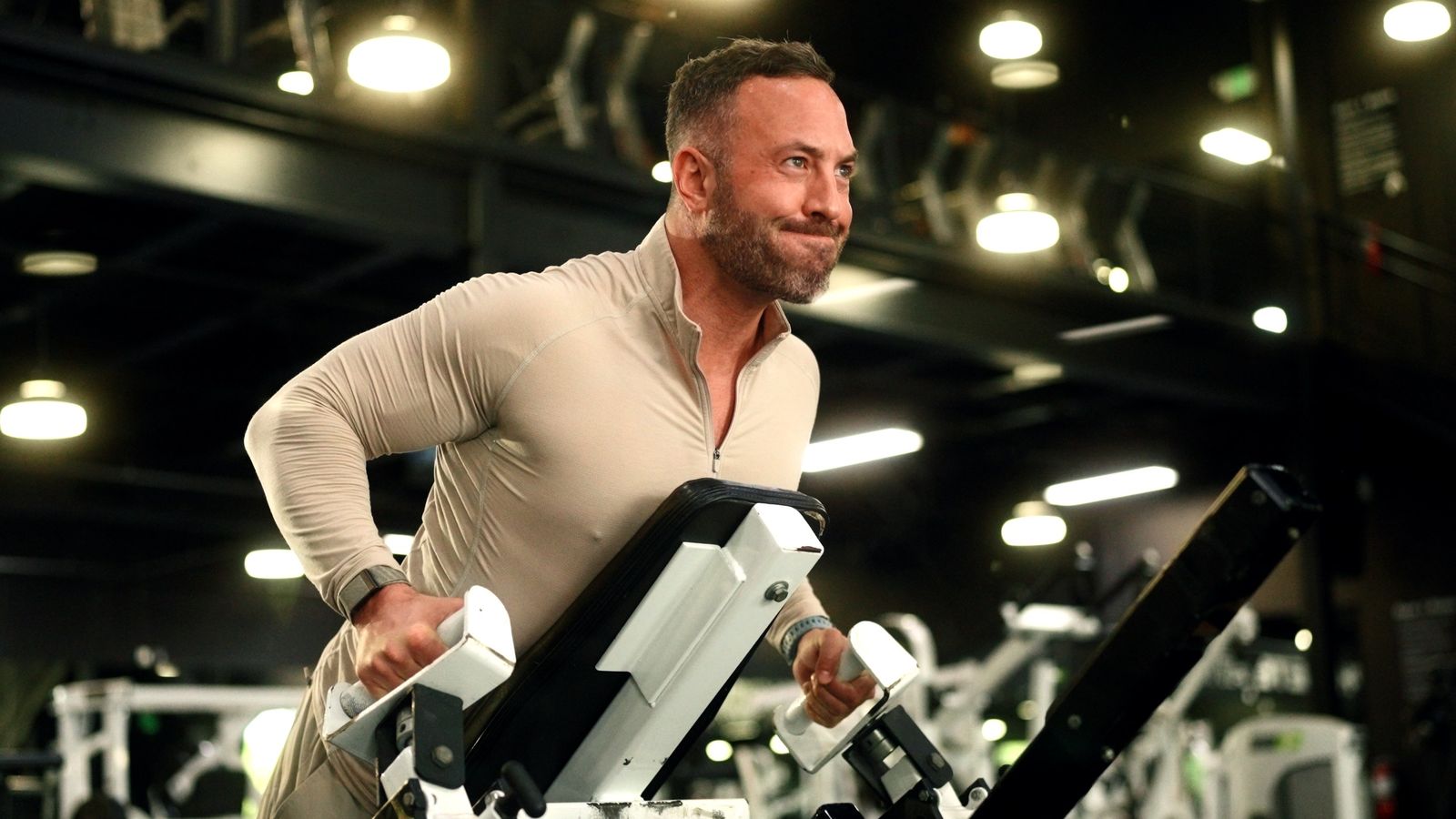 An athlete trains on a machine in a gym